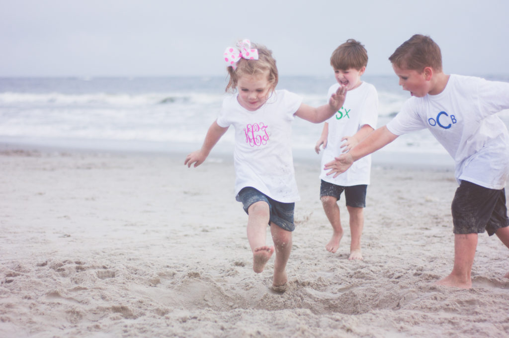 family portraits on the beach ocean city nj jumping in sand